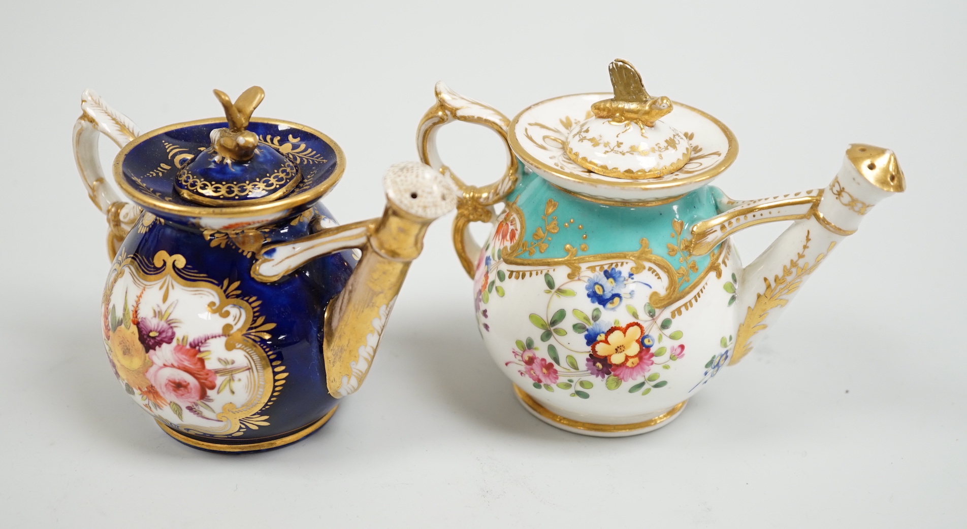 Toy porcelain. Two English rosewater sprinklers, c.1820, possibly Coalport, each modelled in the form of a watering can, tallest 9cm high